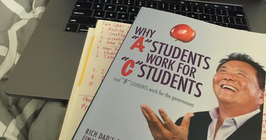 Picture of Robert Kiyosaki's book about Why "A" Students work for "C" Students. 