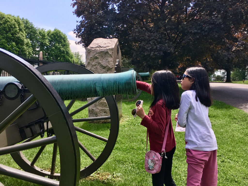 Two kids discovering the civil war canons.